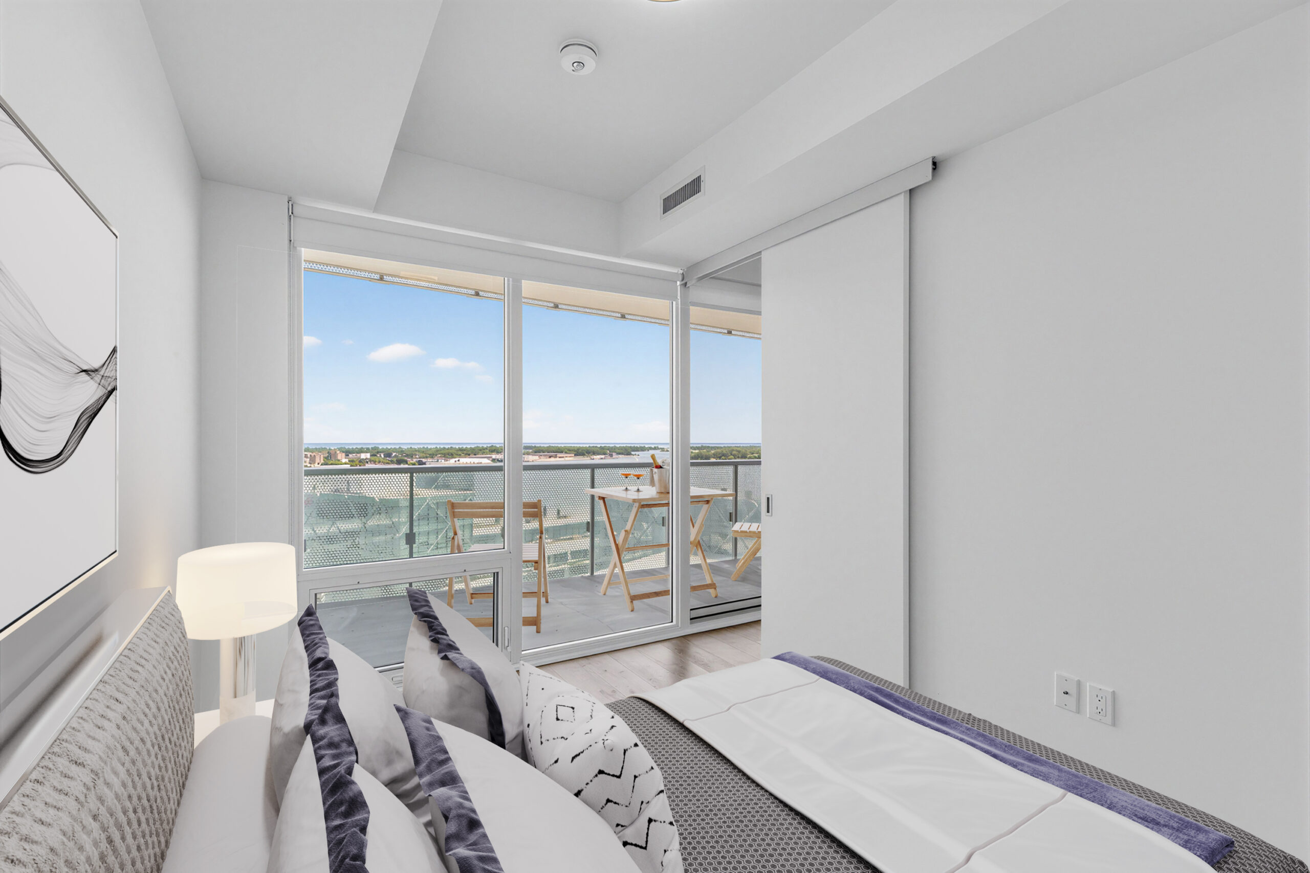 15 Queens Quay E Unit 1901 second bedroom with 3D-rendered furniture, hardwood floors, sliding door, and large glass windows showing balcony and Toronto waterfront.