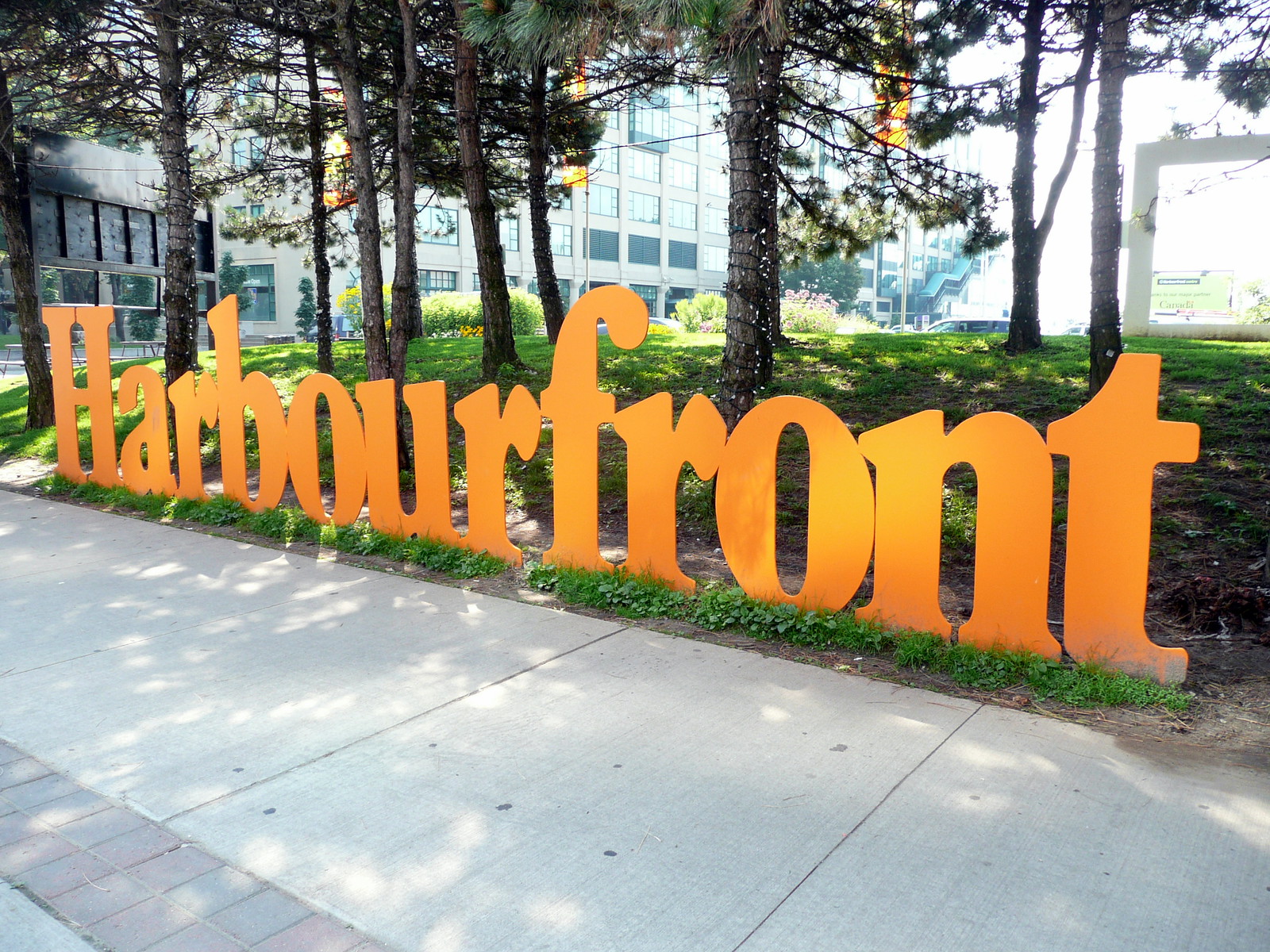 Orange Harbourfront sign on grass in Toronto.