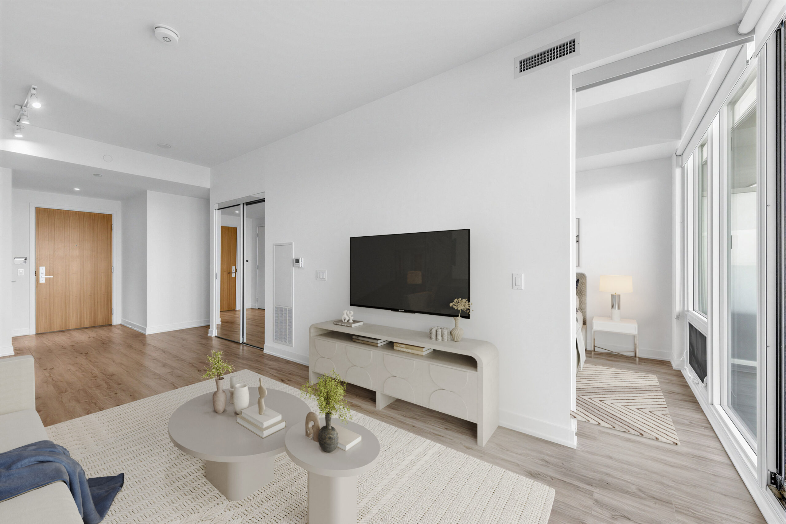 15 Queens Quay E Unit 1901 living room and 2nd bedroom lit by light from balcony and glass windows.