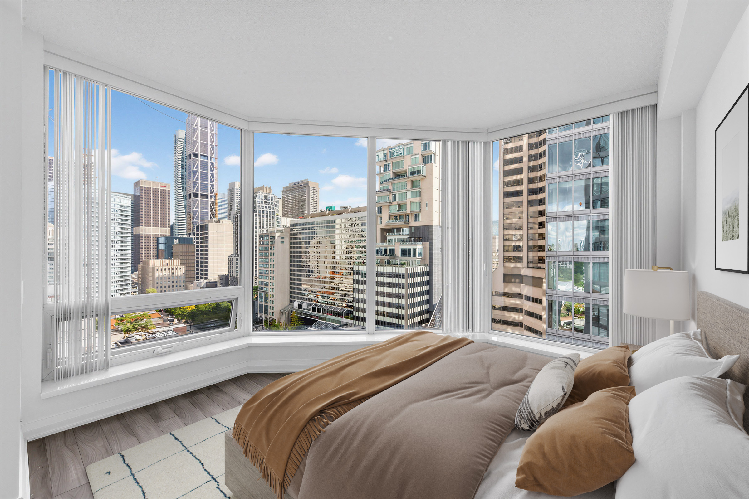 155 Yorkville Ave Unit 1607 primary bedroom with large, wraparound windows showing views of Toronto.