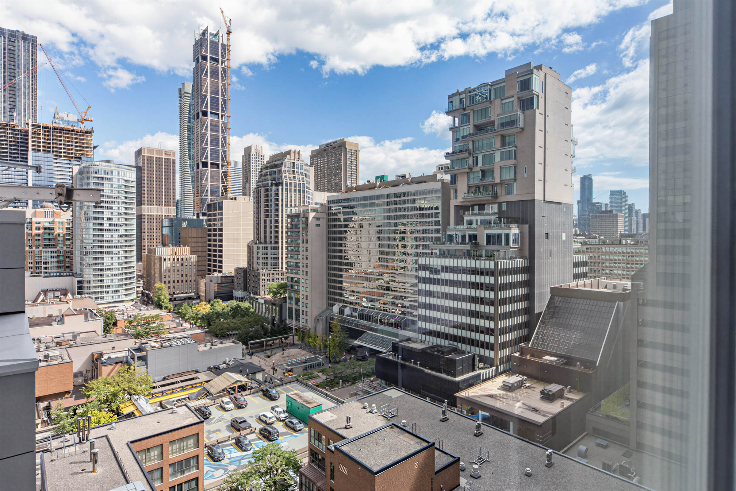 View of Toronto condos and buildings under construction from 155 Yorkville Ave Unit 1607 bedroom windows.