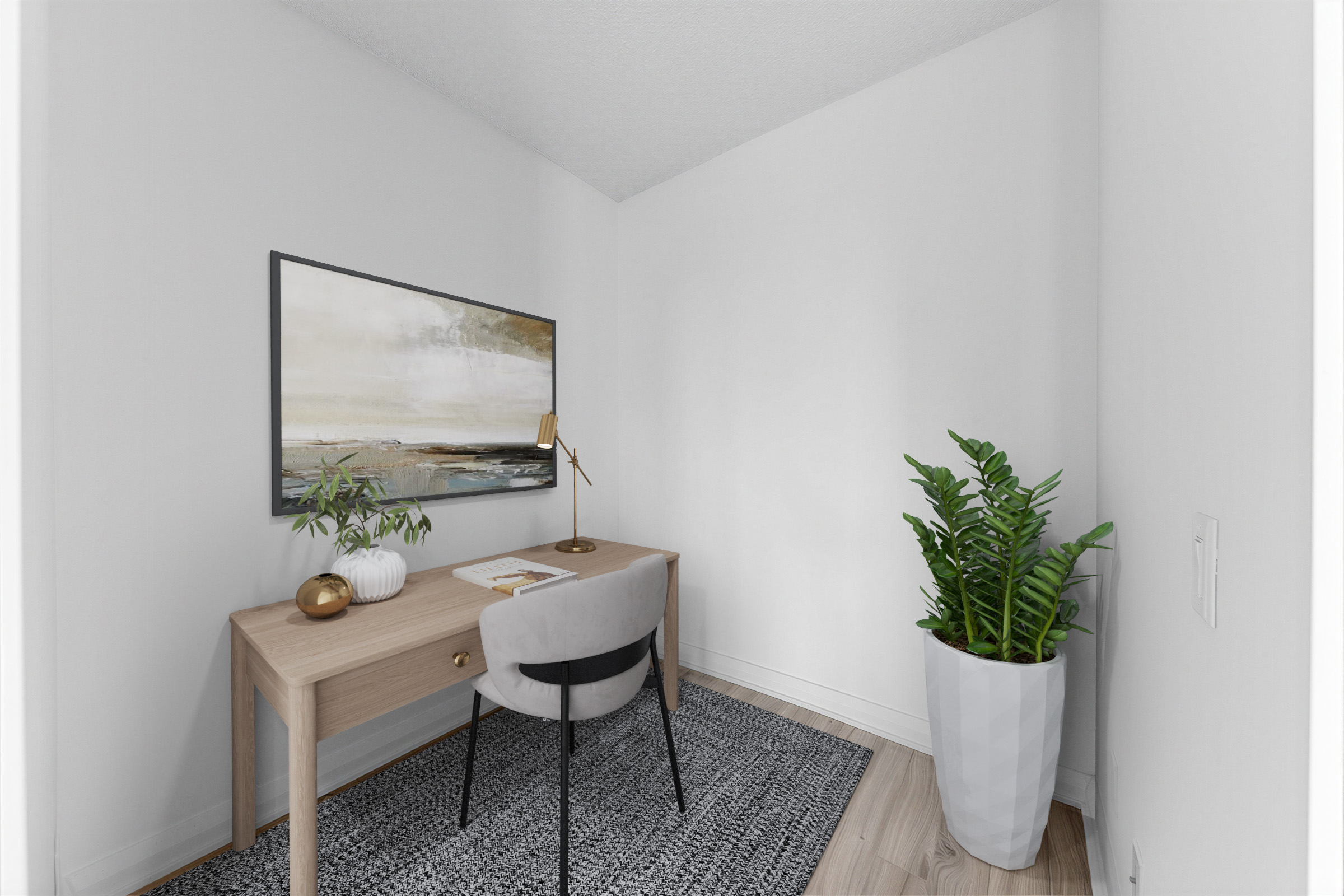 155 Yorkville Ave Unit 1607 den staged as a home office with desk, lamp, chair and plant.