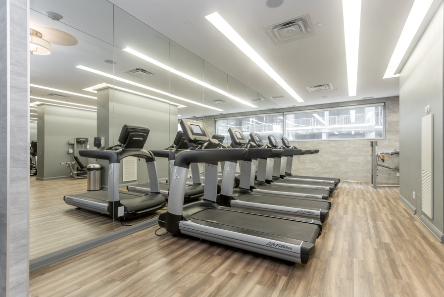 Yorkville Plaza fitness centre with treadmills in front of mirrored walls.